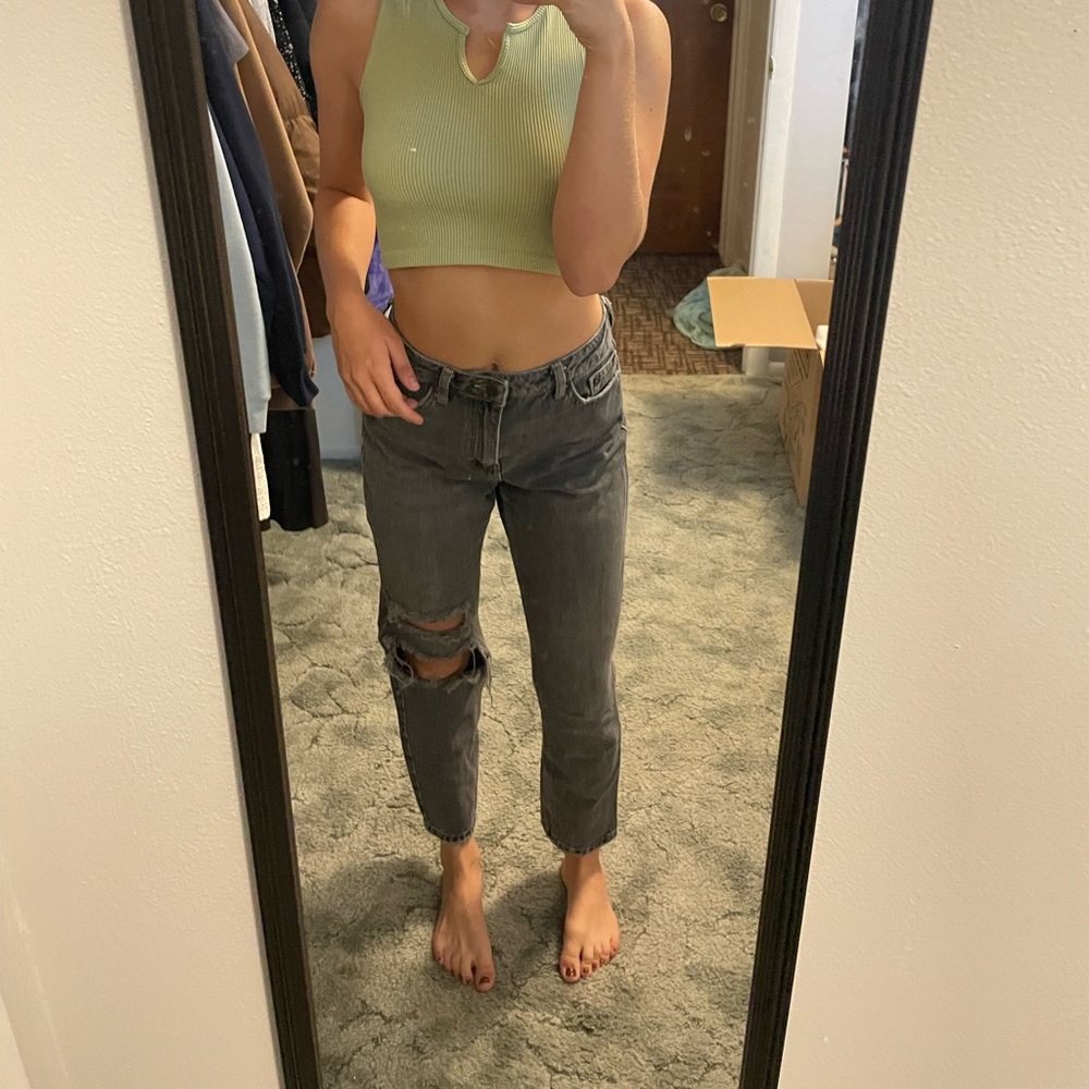 Black ripped jeans with yellow seems